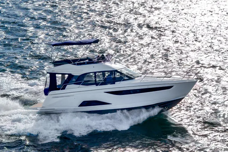 Slide: The Image of 2024 Bavaria R40 yacht cruising on shimmering water. - 13
