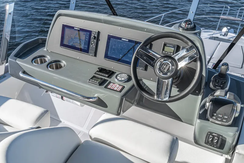 Slide: The Image of 2024 Bavaria R40 yacht helm with modern navigation displays and steering wheel. - 27