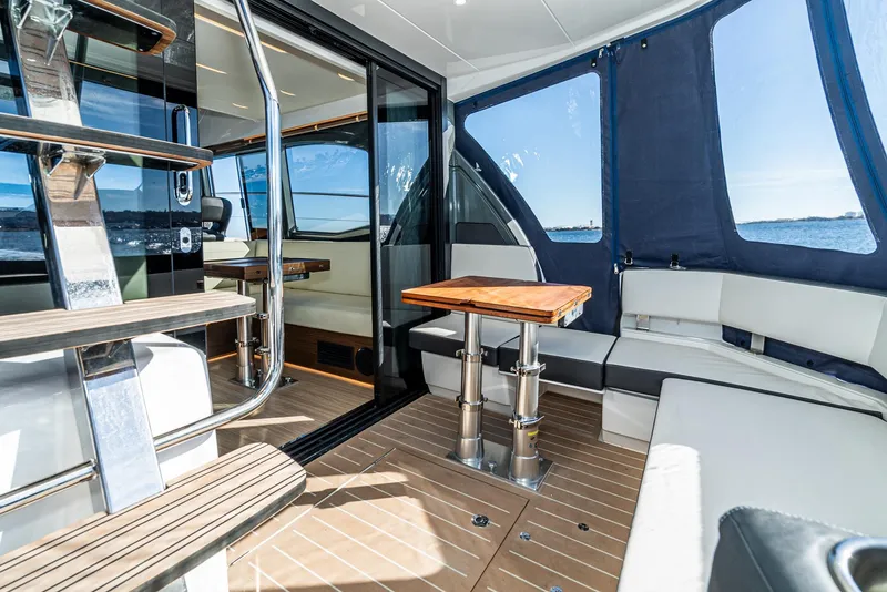 Slide: The Image of 2024 Bavaria R40 yacht interior with seating, table, and ocean view. - 41
