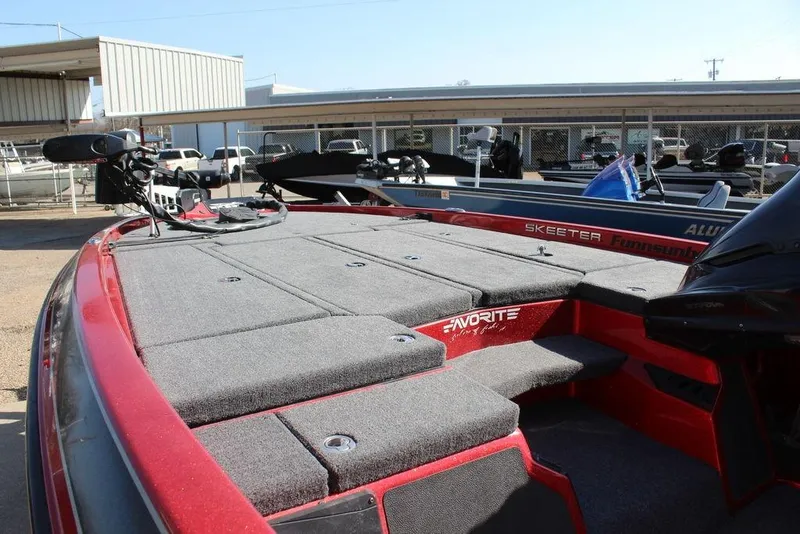 Slide: The Image of 2018 Skeeter ZX225 bass boat with red accents and spacious deck. - 11