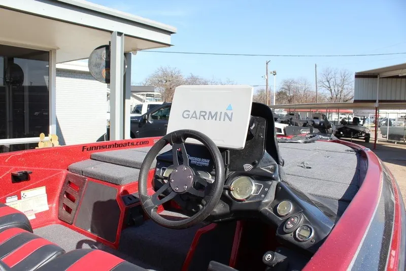 Slide: The Image of 2018 Skeeter ZX225 boat interior with Garmin navigation system and steering wheel. - 12