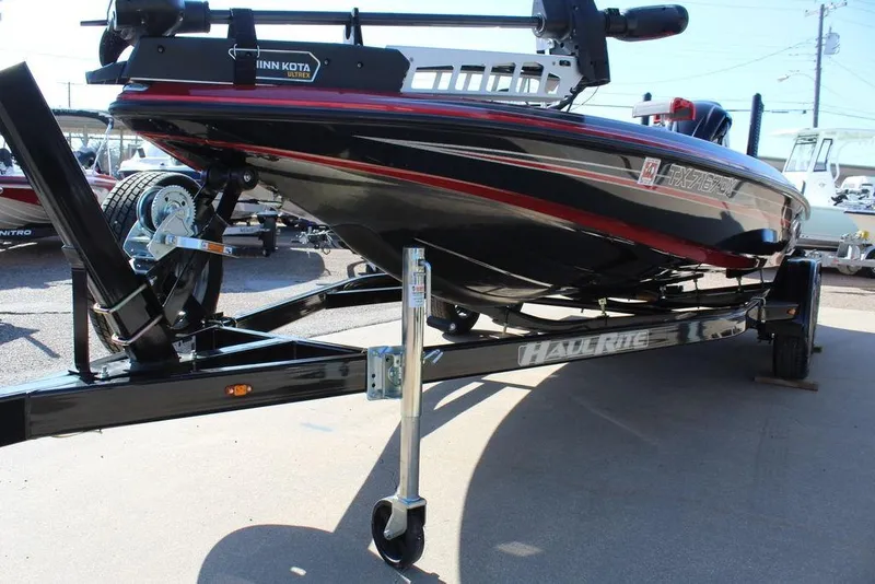 Slide: The Image of 2018 Skeeter ZX225 bass boat on trailer, featuring Minn Kota Ultrex trolling motor. - 13