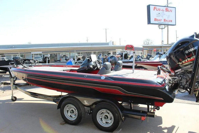 Slide: The Image of 2018 Skeeter ZX225 boat on trailer at dealership, featuring Yamaha engine. - 14