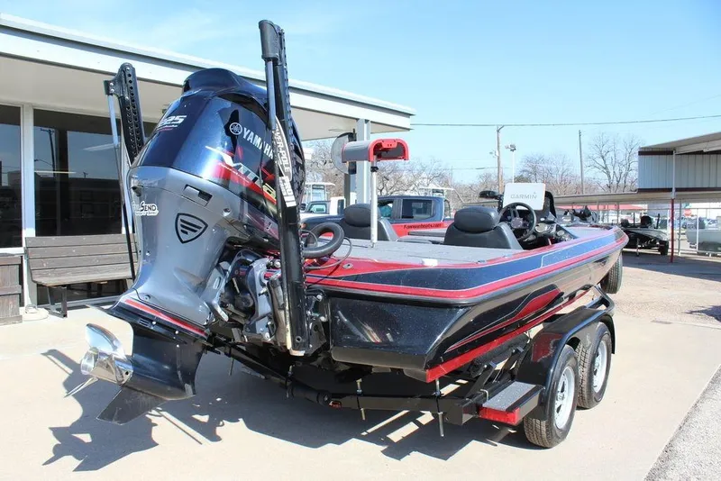 Slide: The Image of 2018 Skeeter ZX225 bass boat with Yamaha engine, parked on a trailer. - 17