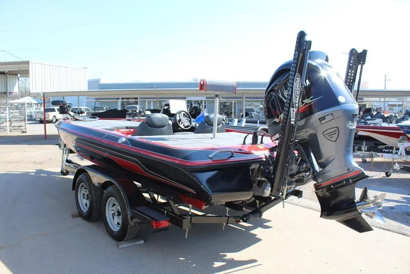 Slide: The Image of 2018 Skeeter ZX225 bass boat with powerful outboard motor, parked on a trailer. - 3