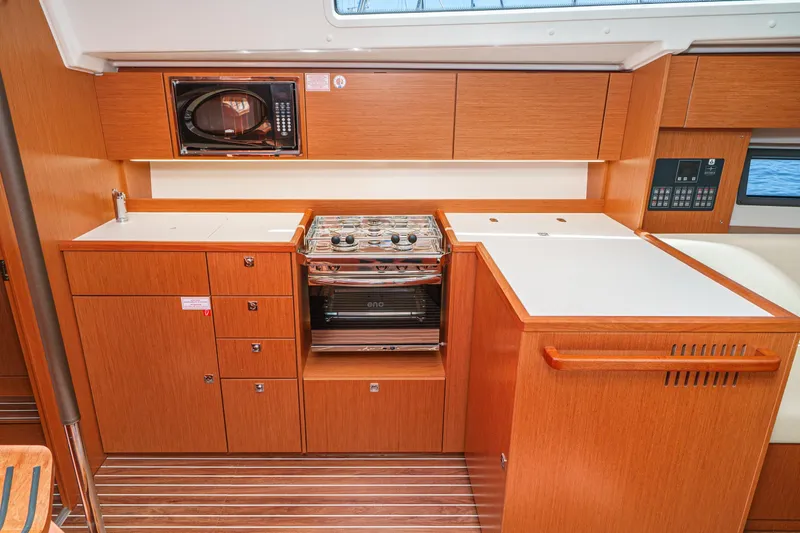 Slide: The Image of Modern kitchen interior of 2023 Bavaria C42 yacht with wood cabinetry and appliances. - 40