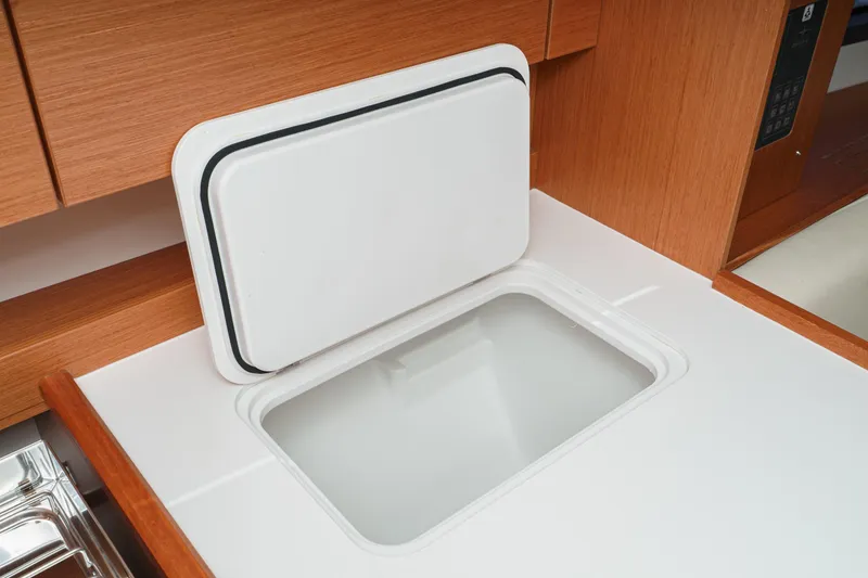 Slide: The Image of Modern kitchen detail in 2023 Bavaria C42 yacht, featuring sleek white countertop and storage. - 42