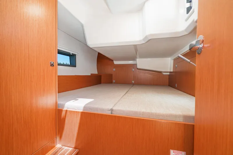 Slide: The Image of 2023 Bavaria C42 yacht interior cabin with wooden finish and comfortable bedding. - 48