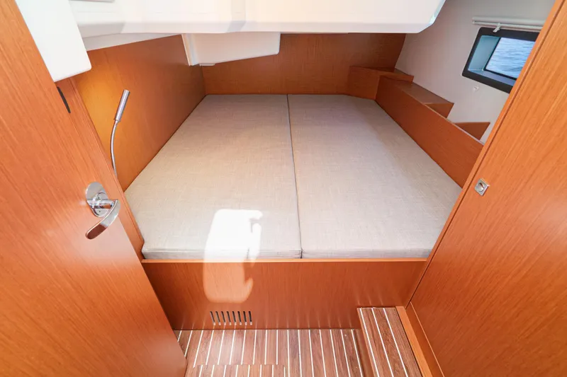 Slide: The Image of 2023 Bavaria C42 yacht cabin with wooden interior and comfortable bedding. - 49