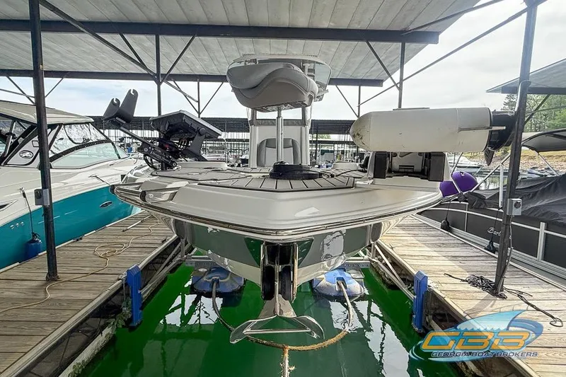 Slide: The Image of 2022 NauticStar 251 Hybrid boat docked, featuring modern design and equipment. - 12