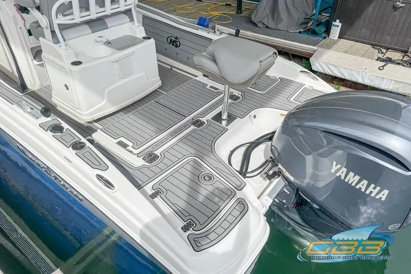 Slide: The Image of 2022 NauticStar 251 Hybrid boat with Yamaha engine, featuring sleek deck design. - 19