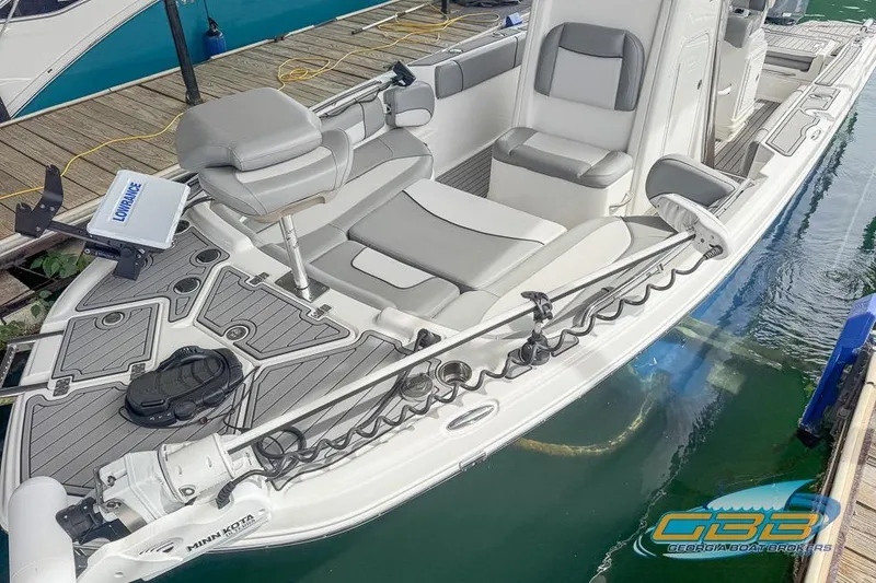 Slide: The Image of 2022 NauticStar 251 Hybrid boat with sleek seating and advanced navigation equipment. - 2
