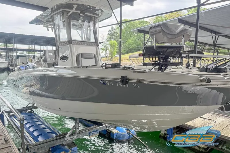 Slide: The Image of 2022 NauticStar 251 Hybrid boat docked, featuring sleek design and modern equipment. - 23