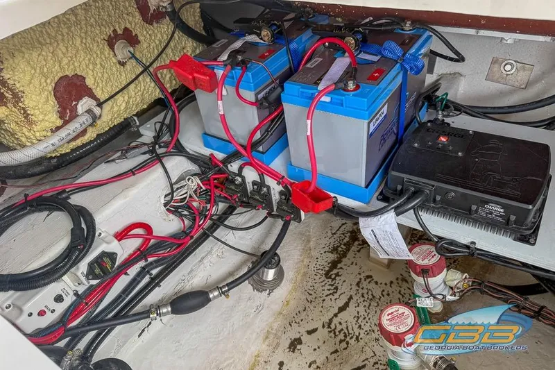 Slide: The Image of 2022 NauticStar 251 Hybrid boat battery compartment with wiring and components. - 26