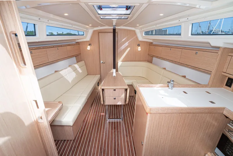 Slide: The Image of Modern interior of 2024 Bavaria Cruiser 34 yacht with light wood finish and ample seating. - 23