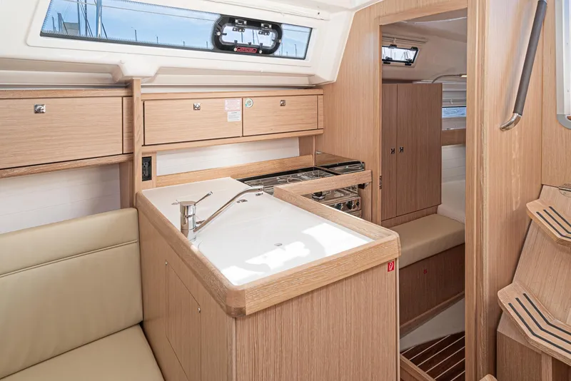 Slide: The Image of Interior of 2024 Bavaria Cruiser 34 yacht with modern kitchen and wooden cabinetry. - 29