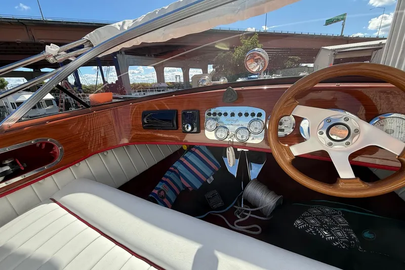 Slide: The Image of Interior of a 1992 Elite Craft Riveria boat with wooden dashboard and steering wheel. - 10
