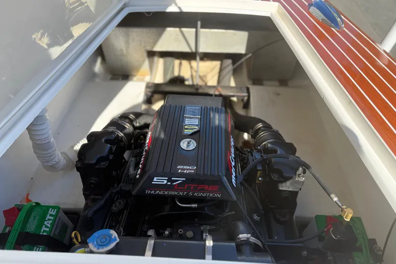 Slide: The Image of Engine compartment of a 1992 Elite Craft Riveria boat, featuring a 5.7L V8 engine. - 11