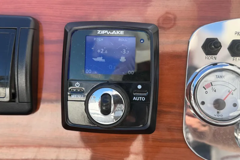 Slide: The Image of Control panel of a 1992 Elite Craft Riveria boat featuring a Zipwake display. - 14