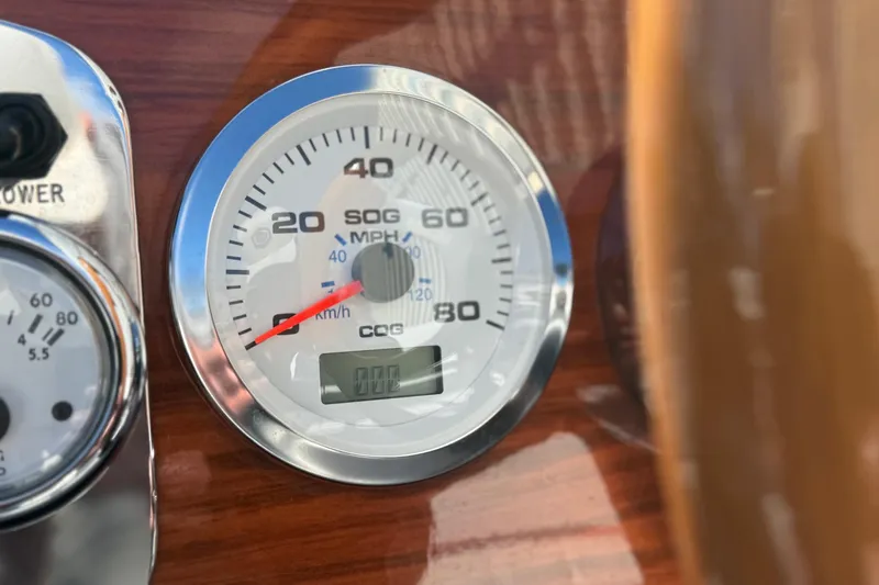 Slide: The Image of Close-up of a 1992 Elite Craft Riveria speedometer, displaying speed in MPH and km/h. - 15