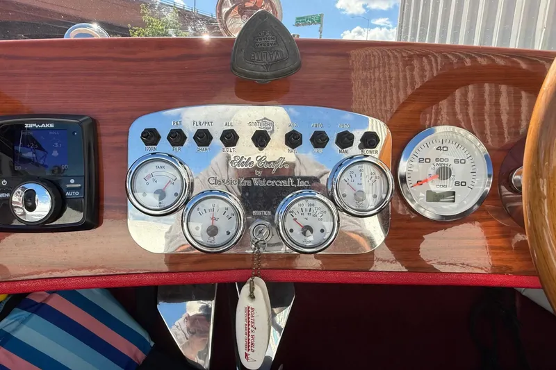Slide: The Image of Dashboard of a 1992 Elite Craft Riveria boat with gauges and controls. - 16