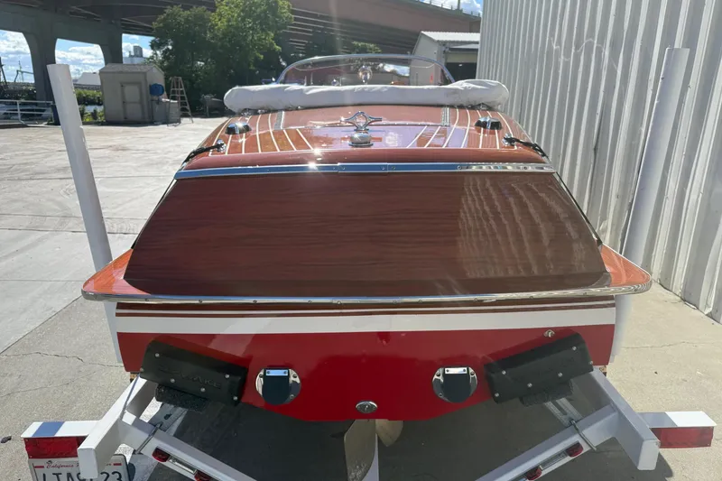 Slide: The Image of 1992 Elite Craft Riveria boat on trailer, showcasing polished wood finish and sleek design. - 4