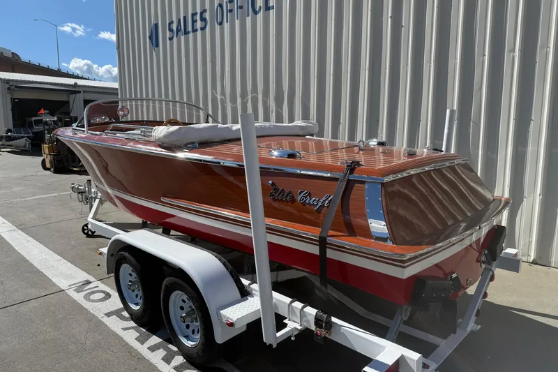 Slide: The Image of 1992 Elite Craft Riveria boat on trailer outside sales office. - 5