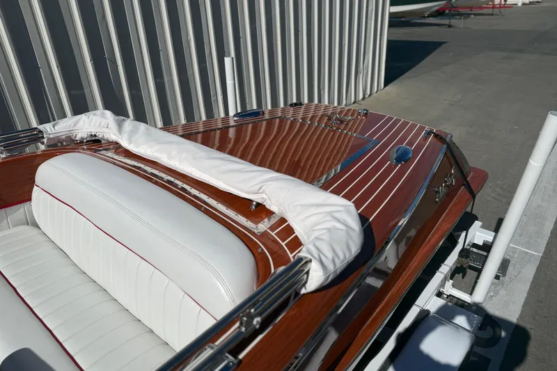 Slide: The Image of 1992 Elite Craft Riveria boat with polished wood deck and white leather seating. - 6