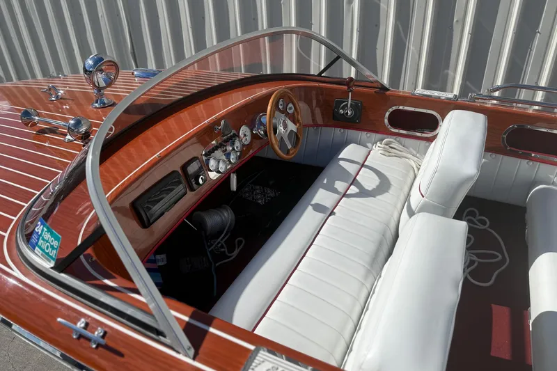 Slide: The Image of Interior of a 1992 Elite Craft Riveria boat with white seating and wooden dashboard. - 8