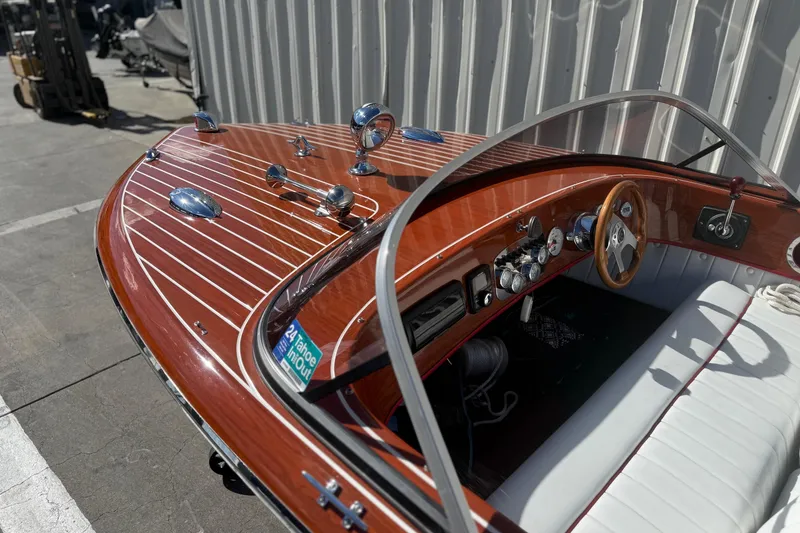 Slide: The Image of 1992 Elite Craft Riveria boat with polished wood finish and classic dashboard design. - 9