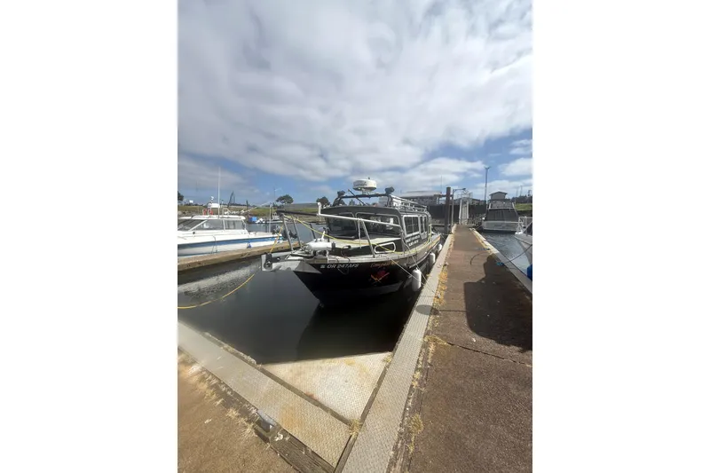 The Image of 2016 North River 29 OFFSHORE boat docked under cloudy sky. - 0