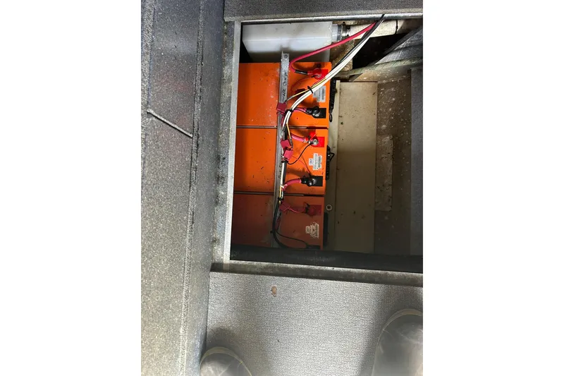 Slide: The Image of Battery compartment of a 2016 North River 29 Offshore boat, showing wiring and connections. - 11