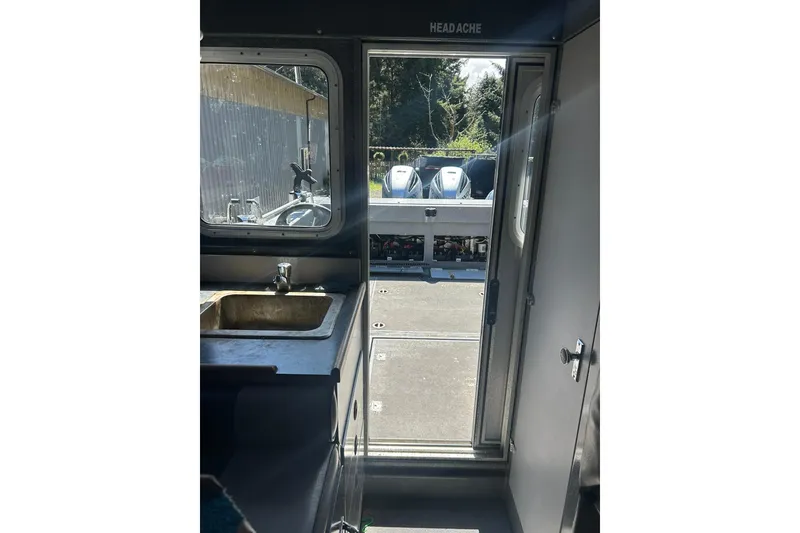 Slide: The Image of Interior view of 2016 North River 29 OFFSHORE boat, featuring a sink and open door. - 14