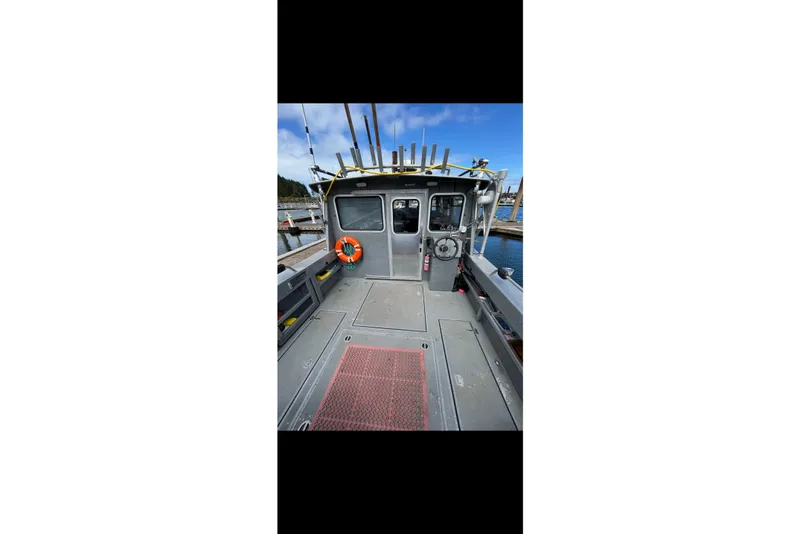Slide: The Image of 2016 North River 29 OFFSHORE boat interior with fishing rods and life preserver. - 15