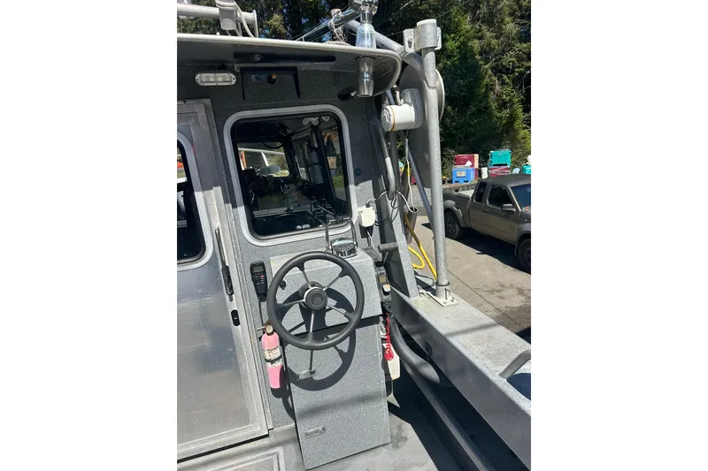 Slide: The Image of 2016 North River 29 Offshore boat helm with steering wheel and controls. - 16