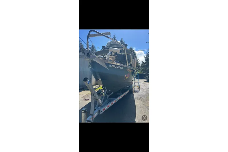 Slide: The Image of 2016 North River 29 Offshore boat on trailer, parked outdoors under clear sky. - 18