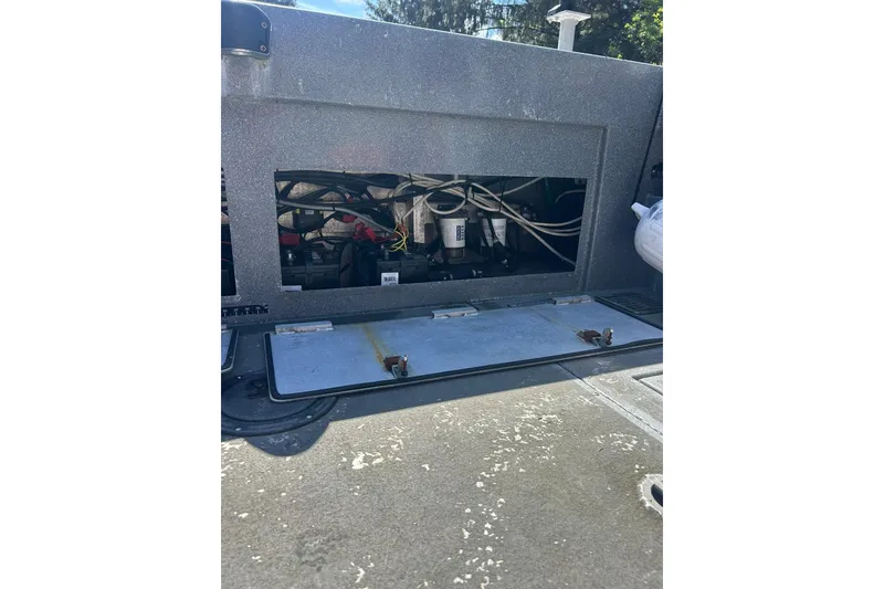 Slide: The Image of 2016 North River 29 Offshore boat engine compartment with visible wiring and components. - 23