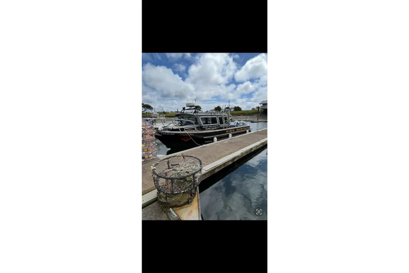 Slide: The Image of 2016 North River 29 OFFSHORE boat docked at marina under cloudy sky. - 24