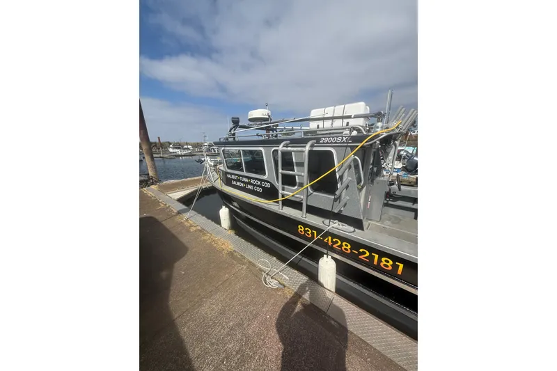 Slide: The Image of 2016 North River 29 OFFSHORE boat docked, featuring fishing equipment and contact information. - 26