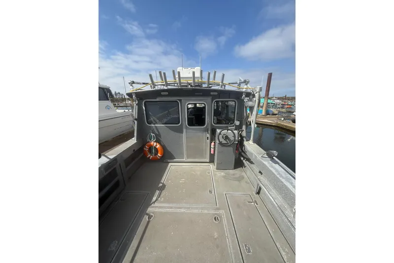 Slide: The Image of 2016 North River 29 OFFSHORE boat docked, featuring spacious deck and cabin. - 27