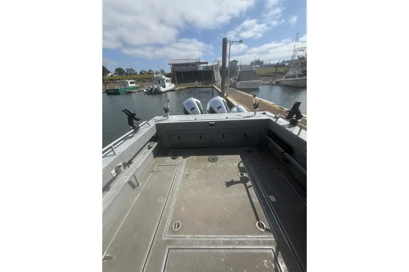 Slide: The Image of 2016 North River 29 Offshore boat docked, featuring spacious deck and dual engines. - 28