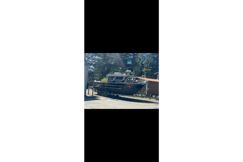 Slide: The Image of 2016 North River 29 Offshore boat parked outdoors on a sunny day. - 3