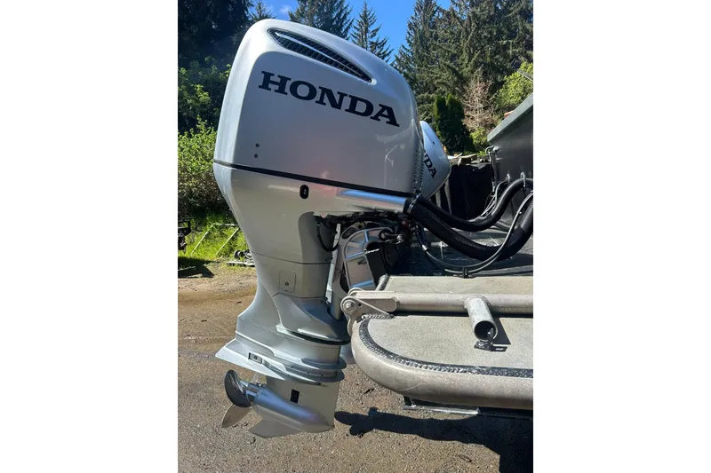 Slide: The Image of 2016 North River 29 Offshore boat with Honda outboard motor in a wooded setting. - 30