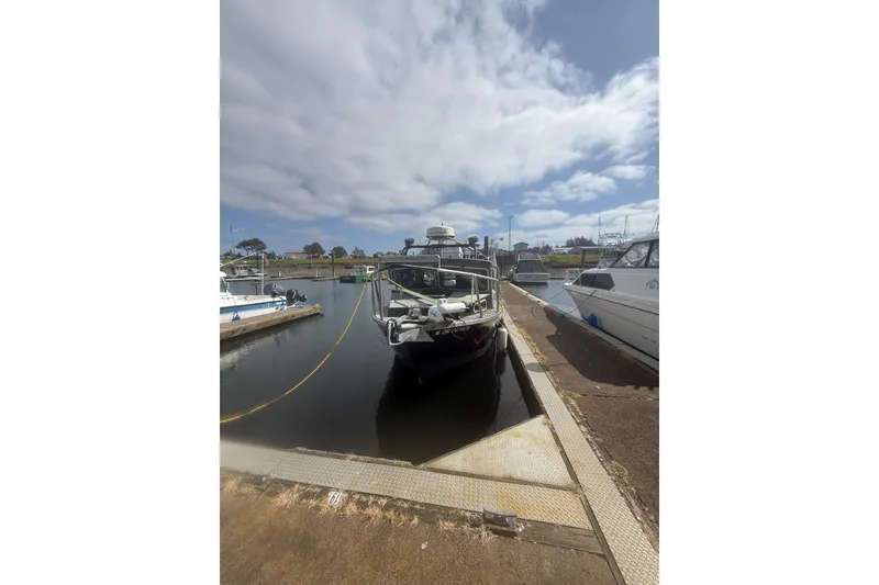 Slide: The Image of 2016 North River 29 Offshore boat docked at a marina under cloudy skies. - 31
