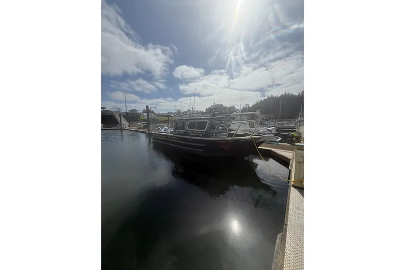 Slide: The Image of 2016 North River 29 OFFSHORE boat docked under a sunny sky. - 32