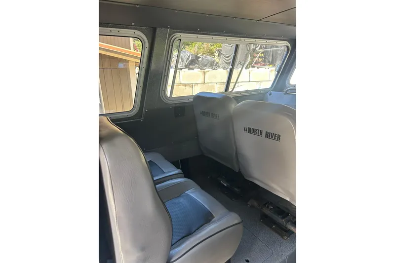 Slide: The Image of Interior of 2016 North River 29 Offshore boat with gray seating and windows. - 4