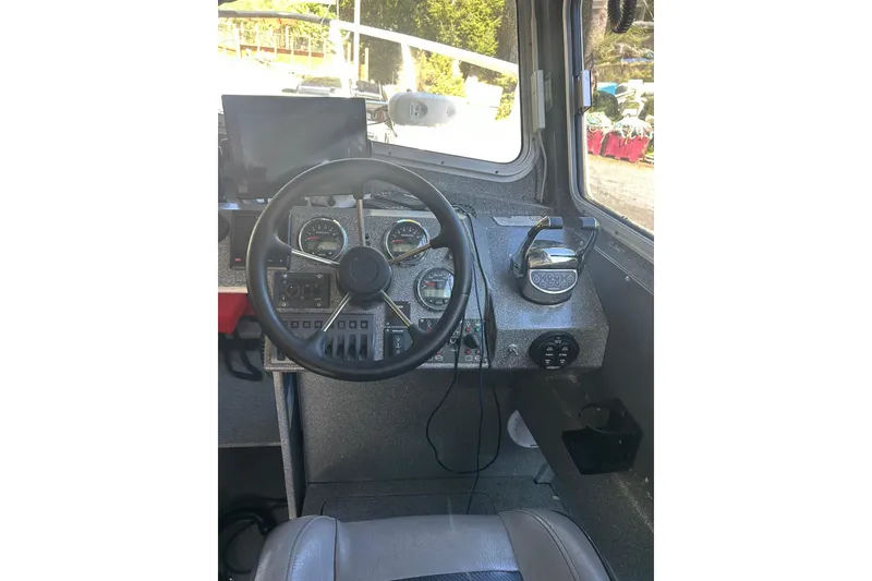 Slide: The Image of Interior view of 2016 North River 29 OFFSHORE boat cockpit with steering wheel and controls. - 6