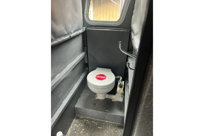 Slide: The Image of 2016 North River 29 OFFSHORE boat interior with compact marine toilet. - 7