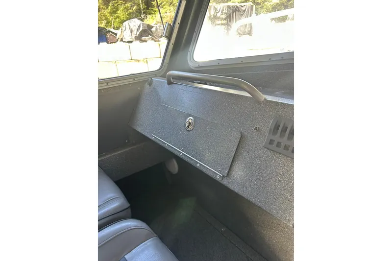 Slide: The Image of Interior view of a 2016 North River 29 Offshore boat, featuring a secure storage compartment. - 8