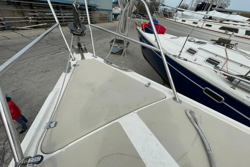 Slide: The Image of Bow view of a 1989 Catalina 30 sailboat in a marina setting. - 10